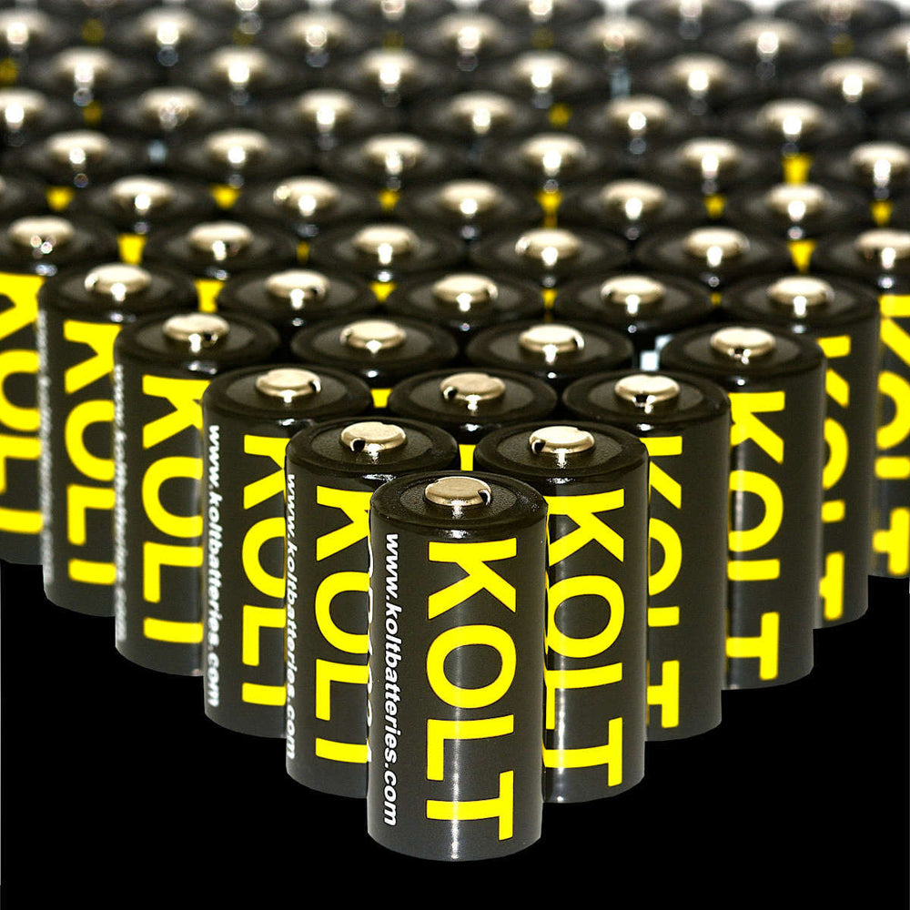 Bulk display of Kolt CR123A Four Pack 1600 mAh disposable batteries with bold yellow branding. Ideal for cameras, scopes, and tactical gear.