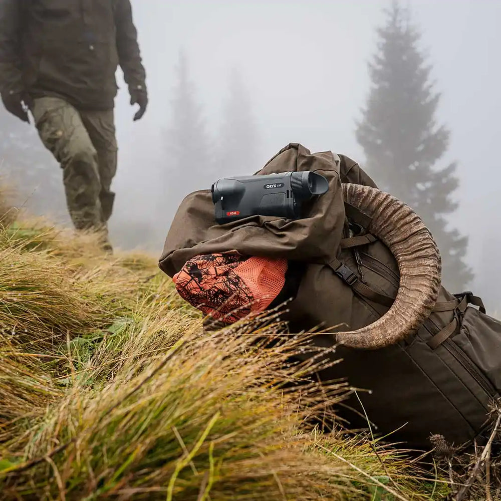 pulsar-oryx-xg35-lrf-on-rucksack-with-blaze-orange-cap